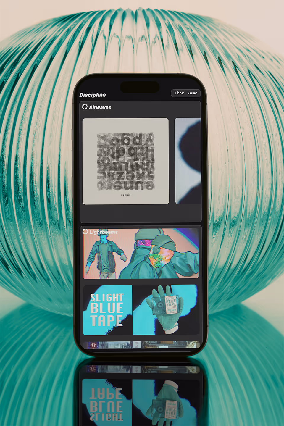 IO Everything website mobile view showing an item page with a bento grid layout of creative works